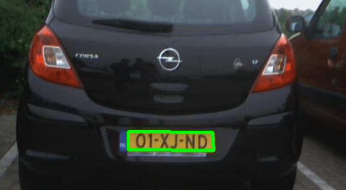 Image of the back of a car with a green bounding box over its license plate